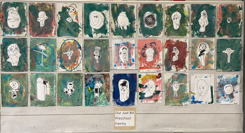 A series of children's drawings on a bulletin board.