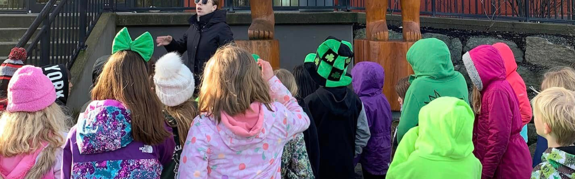 A group of children in brightly coloured coats. 