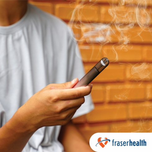 A person holds a vape pen. 