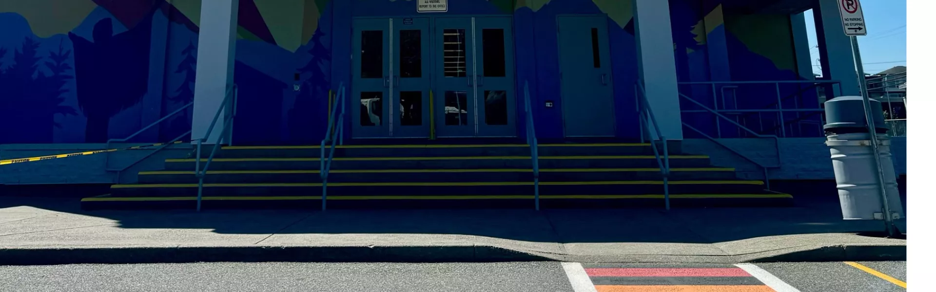 Colourful building with a rainbow sidewalk. 