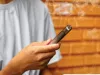 A person holds a vape pen. 